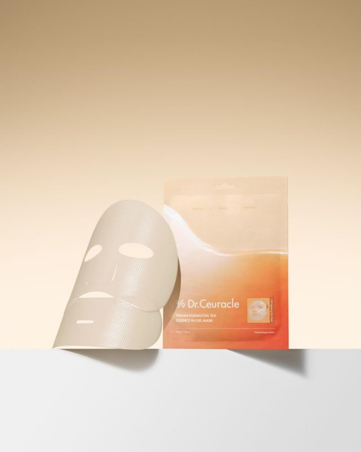 Dr. Ceuracle sheet mask next to its orange and white gradient packaging. Showcases the textured V-Fit Tightening Gel Sheet.