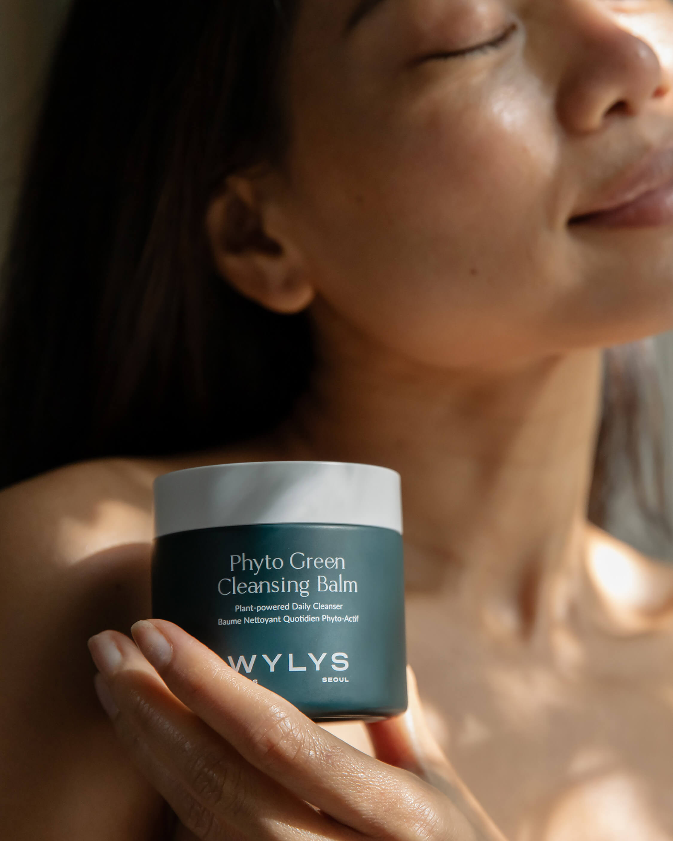 WYLYS Phyto Green Cleansing Balm Plant Powered Oil-based Daily Cleansing Balm All Natural Fresh First Cleanser All Skin Types. Model holding jar. Smiling. Made in Korea. K-beauty.