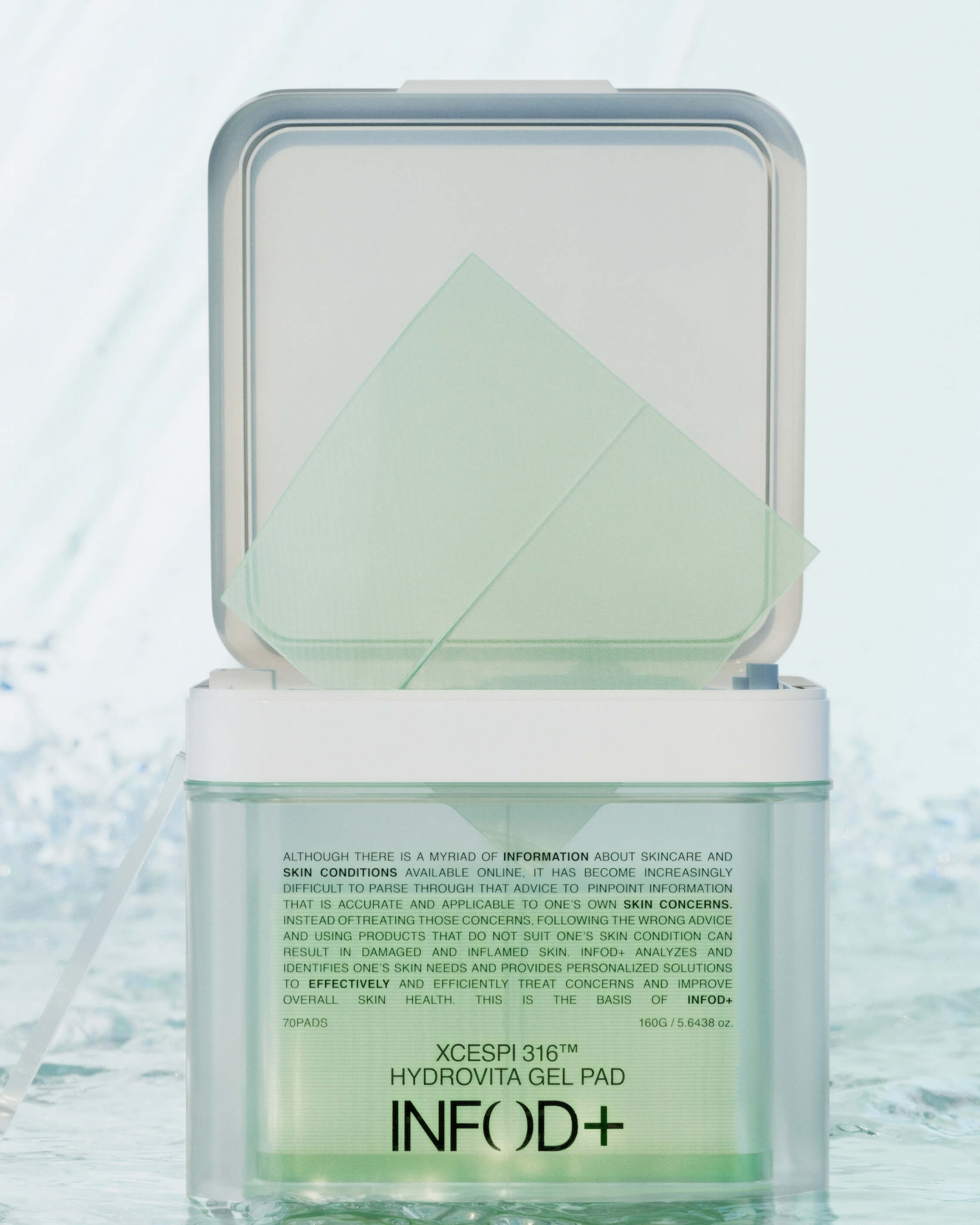 The INFOD+ XCESPI 316™ Hydrovita Gel Pad container open, with the white inner lid propped up to reveal the green gel pad product inside.