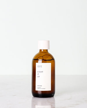 Sioris Light It Up Essener bottle with brightening vitamin C formula on plain background